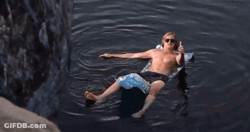 Shirtless Man Floating On Raft Giving Thumbs Up GIF