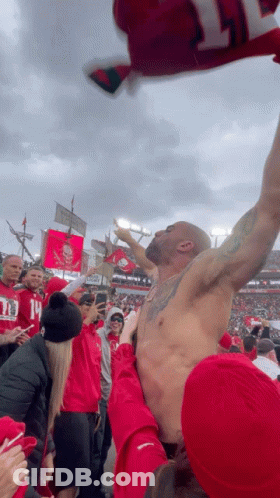 Shirtless Man Held Up By Fans GIF