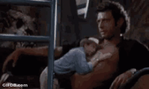 Shirtless Man Holding Baby On Bed GIF