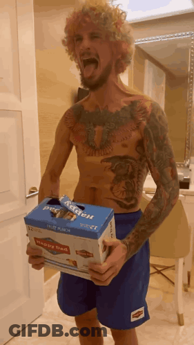 Shirtless Man Holding Box Saying Happy Bed GIF