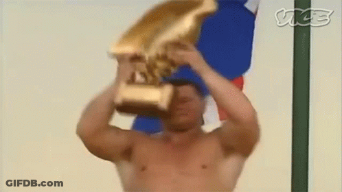 Shirtless Man Holding Gold Trophy GIF