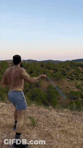 Shirtless Man Holding Hose In Field GIF