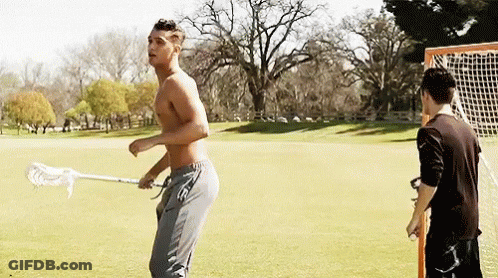 Shirtless Man Holding Lacrosse Stick With Another Man Behind GIF