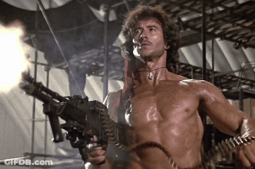 Shirtless Man Holding Machine Gun GIF