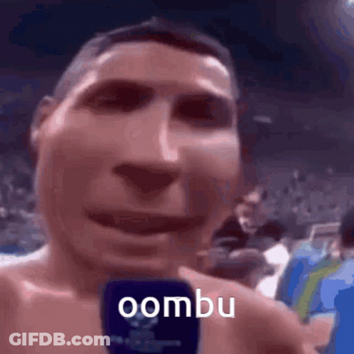 Shirtless Man Holding Microphone Says Oombu GIF