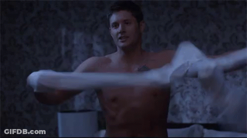 Shirtless Man Holding Pillow Over Head On Bed GIF