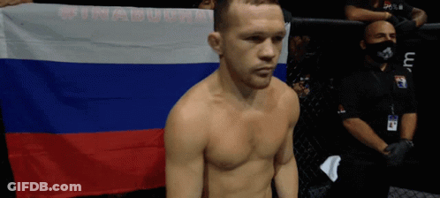Shirtless Man Holding Russian Flag In Front Of Cage GIF