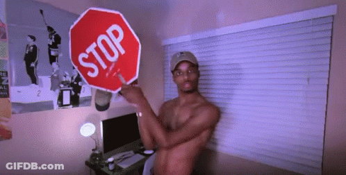 Shirtless Man Holding Stop Sign In Front Of Window GIF