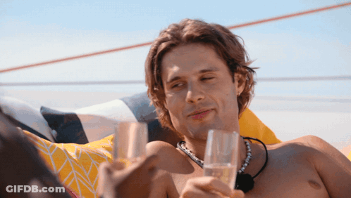 Shirtless Man Holding Two Glasses Of Champagne GIF
