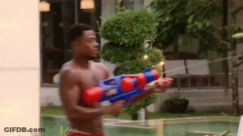 Shirtless Man Holding Water Gun By Pool GIF