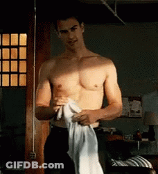 Shirtless Man Holding White Shirt By Window GIF