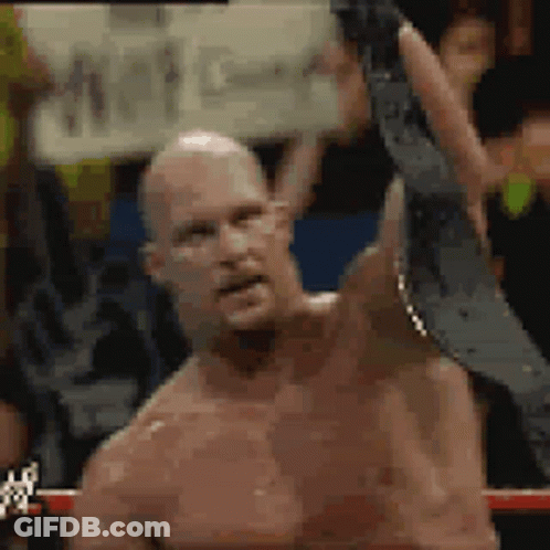 Shirtless Man Holding Wrestling Belt In Boxing Ring GIF
