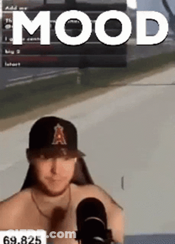Shirtless Man In Baseball Cap Sitting In Front Of Microphone GIF