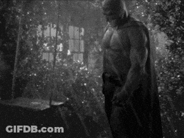 Shirtless Man In Batman Costume In Dark Room GIF