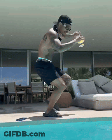 Shirtless Man In Black Shorts Jumping Into Pool GIF