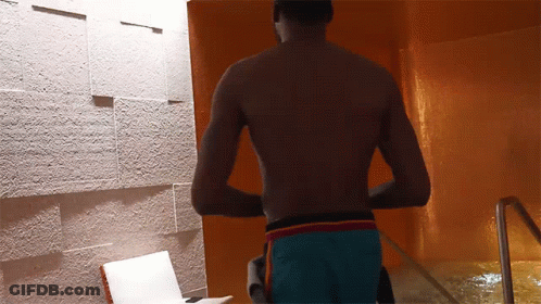Shirtless Man In Blue Shorts By Pool GIF