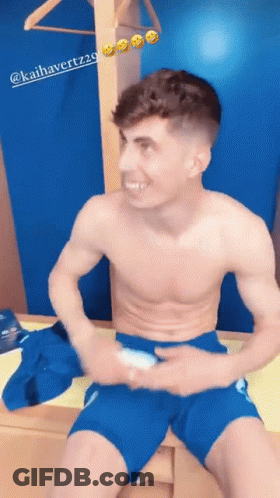 Shirtless Man In Blue Shorts Sitting On Dresser GIF
