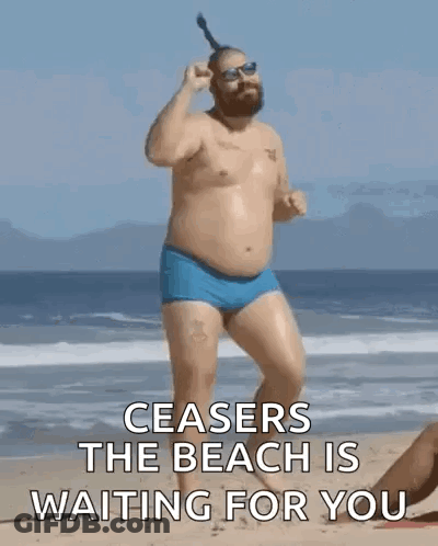 Shirtless Man In Blue Swim Trunks On Beach GIF