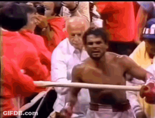 Shirtless Man In Boxing Ring Surrounded By People GIF