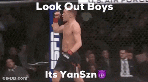 Shirtless Man In Cage With Fist Up Saying Look Out Boys Its Yanszn GIF