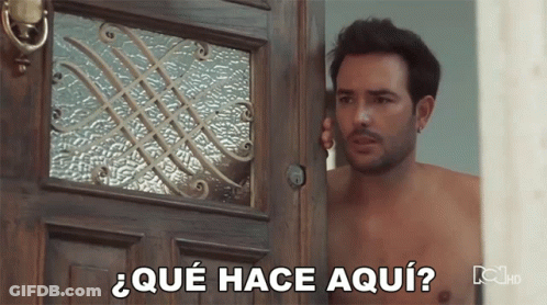 Shirtless Man In Front Of Door Saying Que Hace Aqui GIF