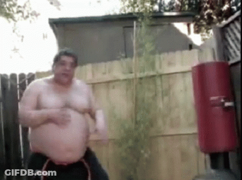 Shirtless Man In Front Of Fence And Water Cooler GIF