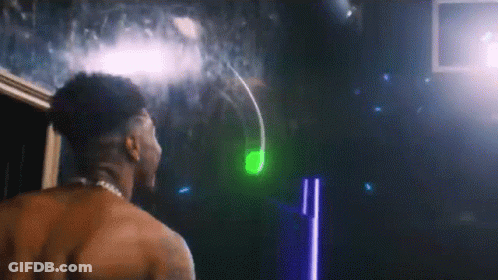 Shirtless Man In Front Of Mirror With Green Light GIF