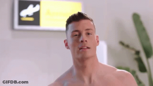 Shirtless Man In Front Of Sign Saying A GIF