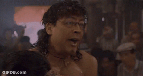 Shirtless Man In Glasses And Headband Beside Woman GIF