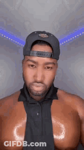 Shirtless Man In Hat And Tie GIF