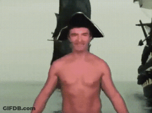 Shirtless Man In Pirate Hat In Front Of Statue GIF