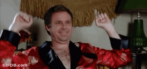 Shirtless Man In Red Robe Raising Arms GIF