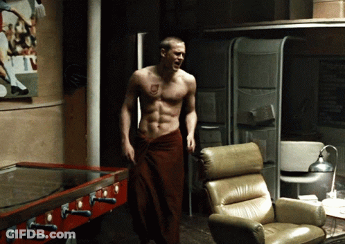 Shirtless Man In Red Towel Standing In Room GIF
