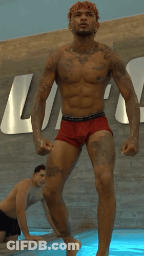 Shirtless Man In Red Underwear In Front Of Tommy Hilfiger Sign GIF