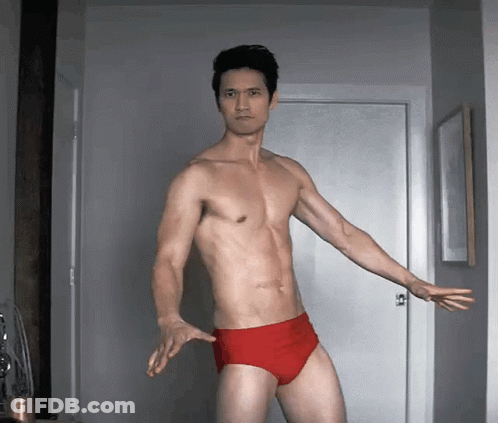 Shirtless Man In Red Underwear Standing By Door GIF
