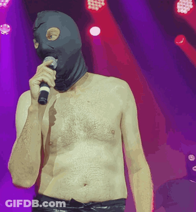Shirtless Man In Ski Mask Holding Microphone GIF
