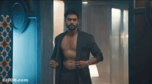 Shirtless Man In Suit In Dark Room GIF