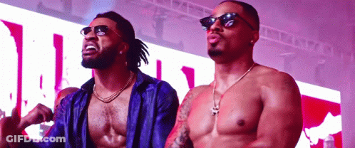 Shirtless Man In Sunglasses Next To Another Man GIF