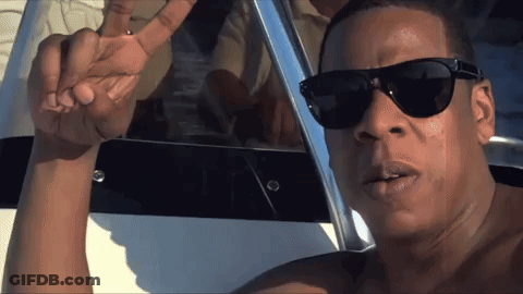 Shirtless Man In Sunglasses Standing In Front Of Boat GIF