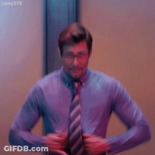 Shirtless Man In Tie And Glasses Taking Off Shirt GIF