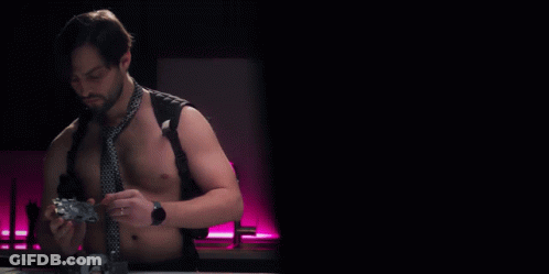 Shirtless Man In Tie Holding Controller With NSFW Teardowns GIF