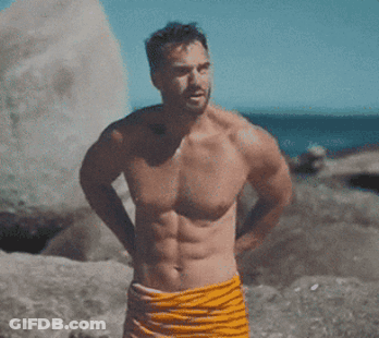 Shirtless Man In Towel On Beach GIF