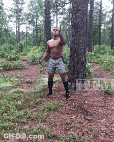 Shirtless Man In Woods Holding Sword Giving Middle Finger GIF