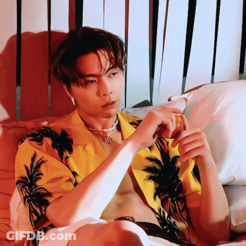 Shirtless Man In Yellow Palm Tree Shirt On Bed GIF