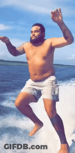 Shirtless Man Jumping Into Water From Boat GIF