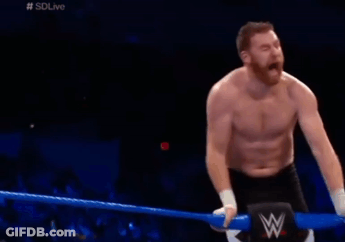 Shirtless Man Kneeling In Wrestling Ring With W Logo GIF