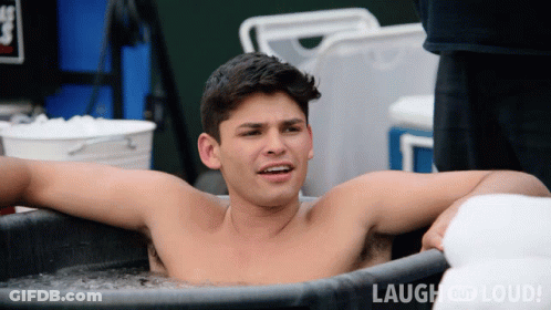Shirtless Man Laying In Tub Of Ice With Laugh And Loud GIF
