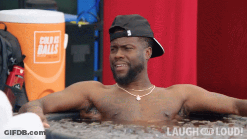 Shirtless Man Laying In Tub Of Ice With Orange Cooler Cold As Balls GIF