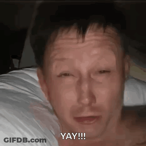Shirtless Man Laying On Bed Saying Yay GIF
