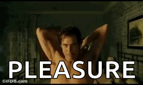 Shirtless Man Laying On Bed With Arms Outstretched Saying Pleasure GIF